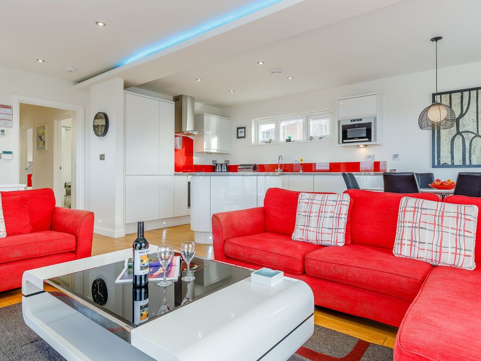 A living room with a sofa and coffee table at Signature Lodge Pet 4 in Portreath