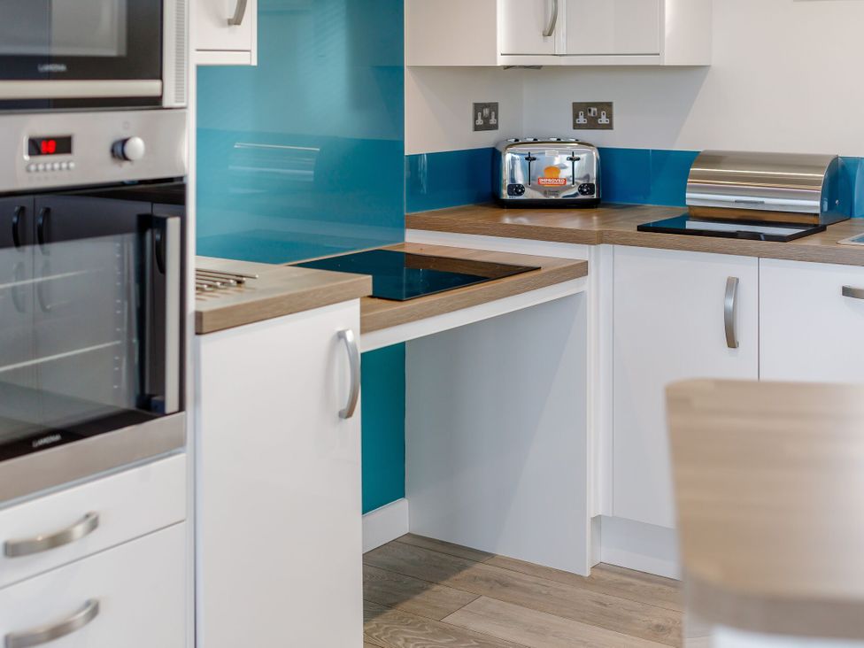 A kitchen with a toaster and oven at Signature Assisted Living 5 Portreath