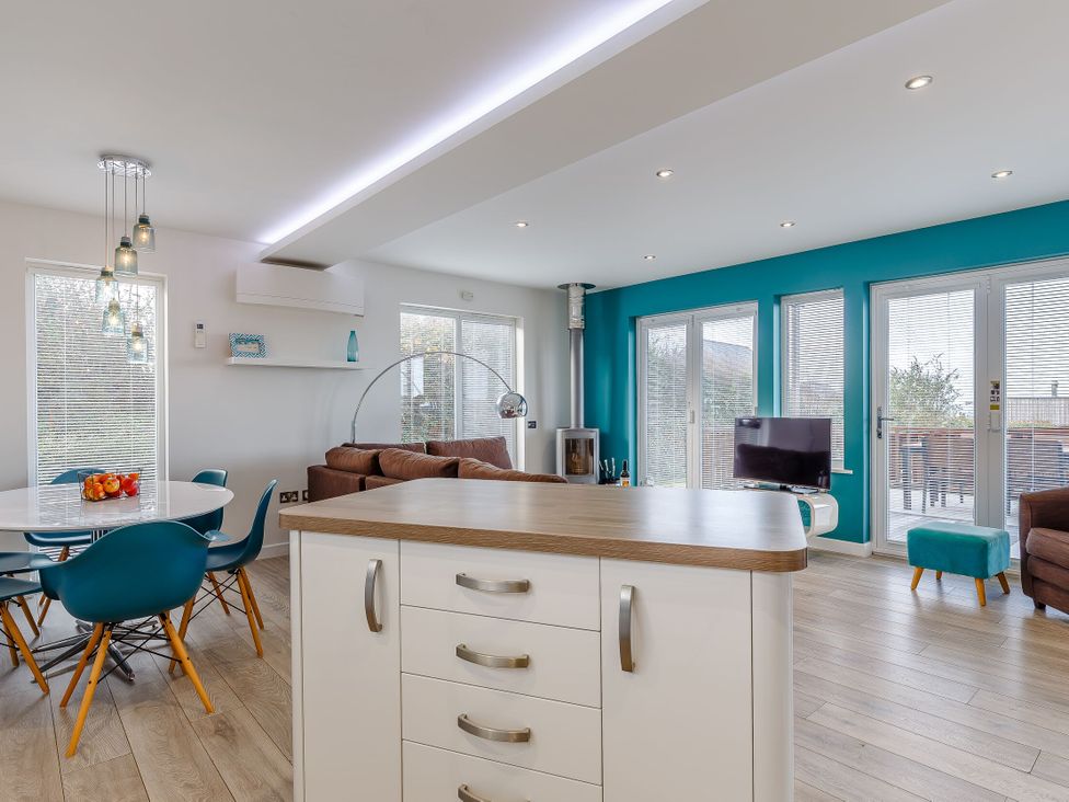 A living room with a table and chairs at Signature Assisted Living 5 in Portreath