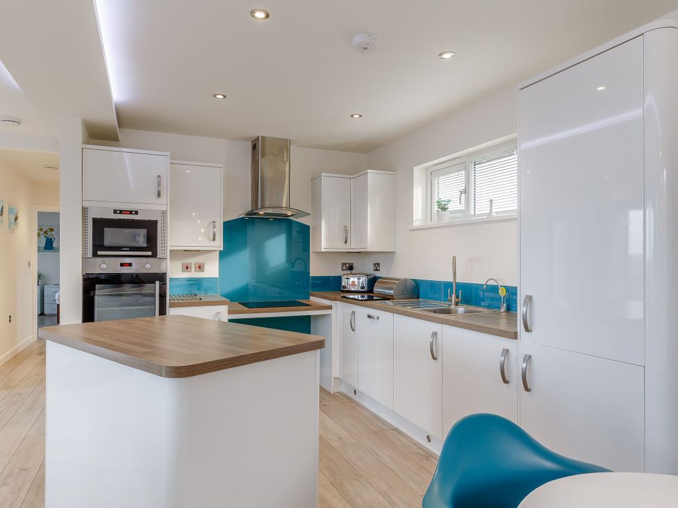 A kitchen with appliances and cabinetry at Signature Assisted Living 5 Portreath