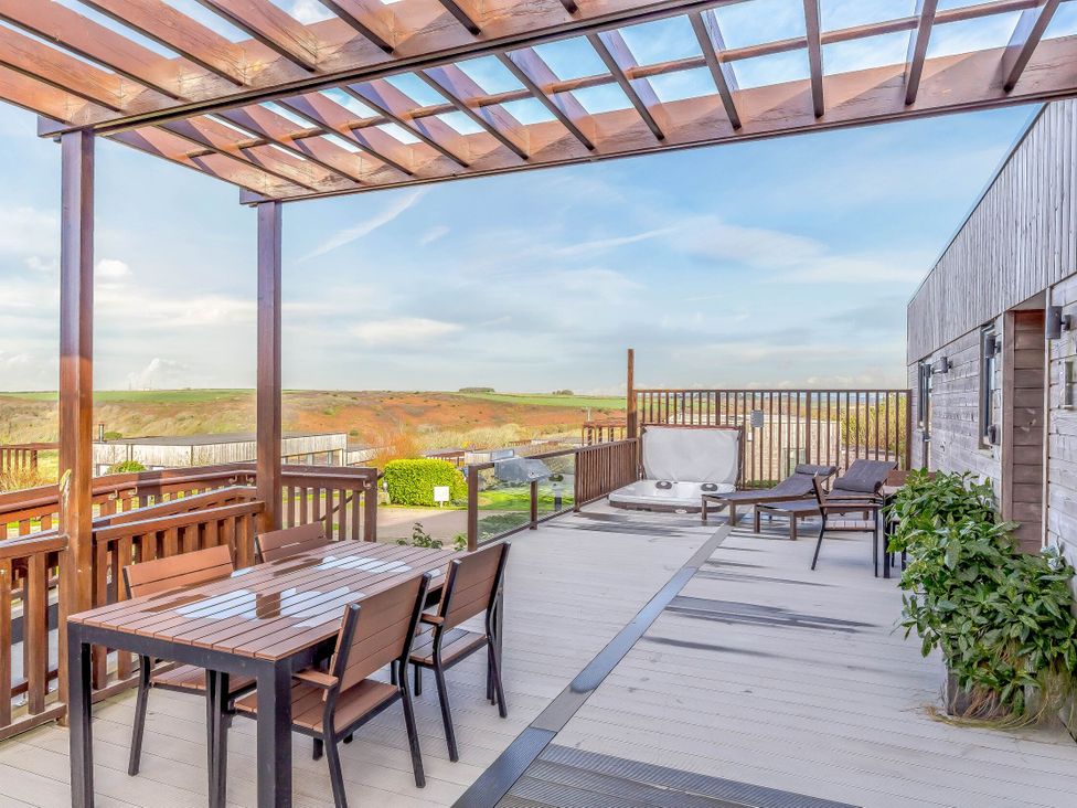 An outdoor area with a table and chairs at Signature Assisted Living 5 Portreath