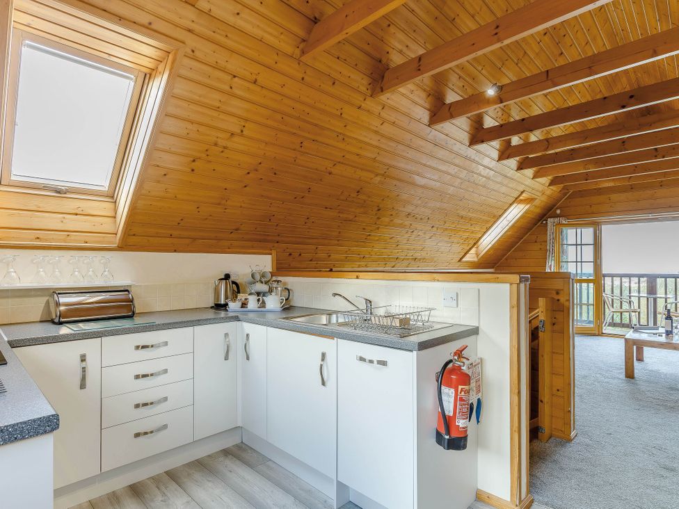 A kitchen with a sink and window at Scandinavian Lodge Pet in Portreath