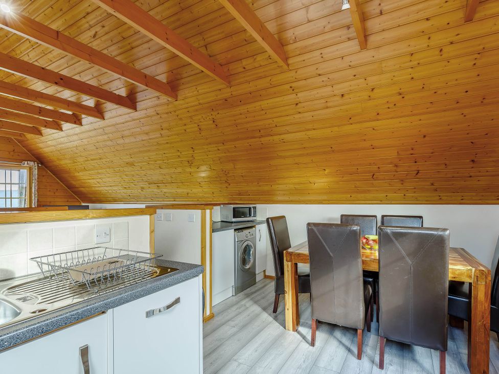 A kitchen with a dining area at Scandinavian Lodge Pet Portreath