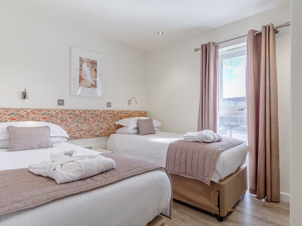 A bedroom with two beds and a window at Signature Lodge 6 in Portreath