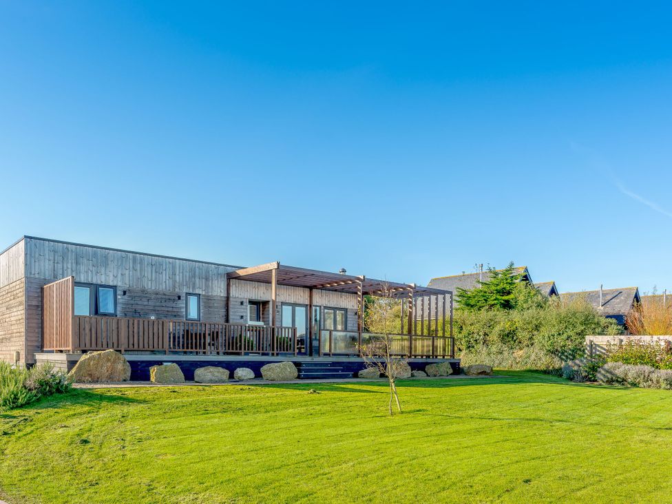 A house with a deck and windows at Signature Lodge Pet 6 Portreath