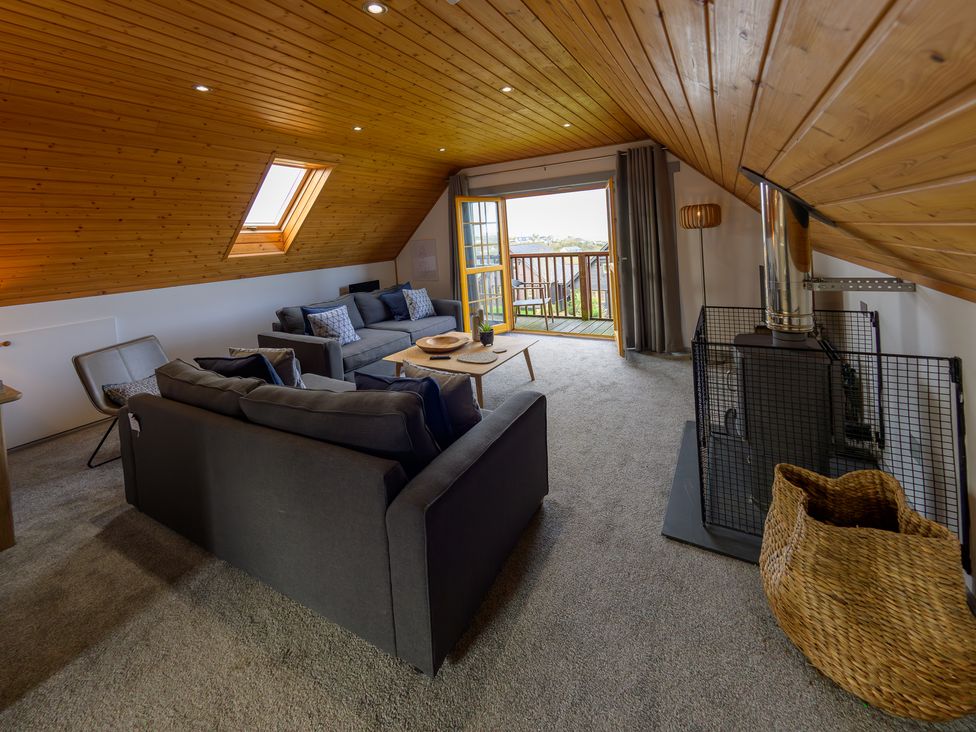 A living room with a sofa and coffee table at Senara Hot Tub Lodge (Pet) Portreath