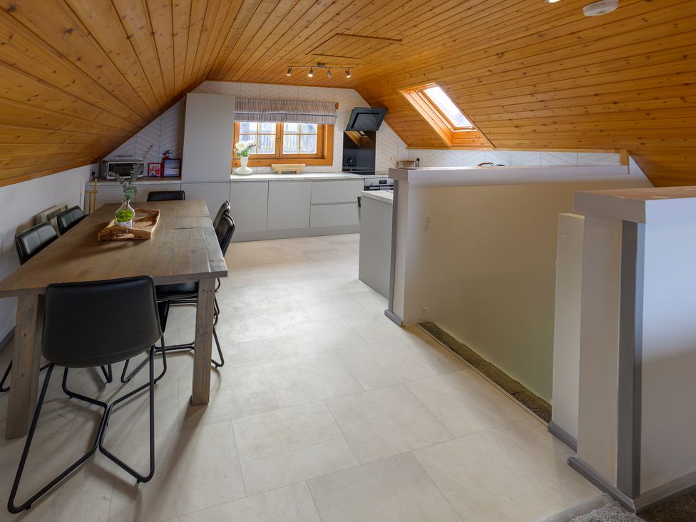 A kitchen with a table and chairs at Senara Hot Tub Lodge (Pet) Portreath