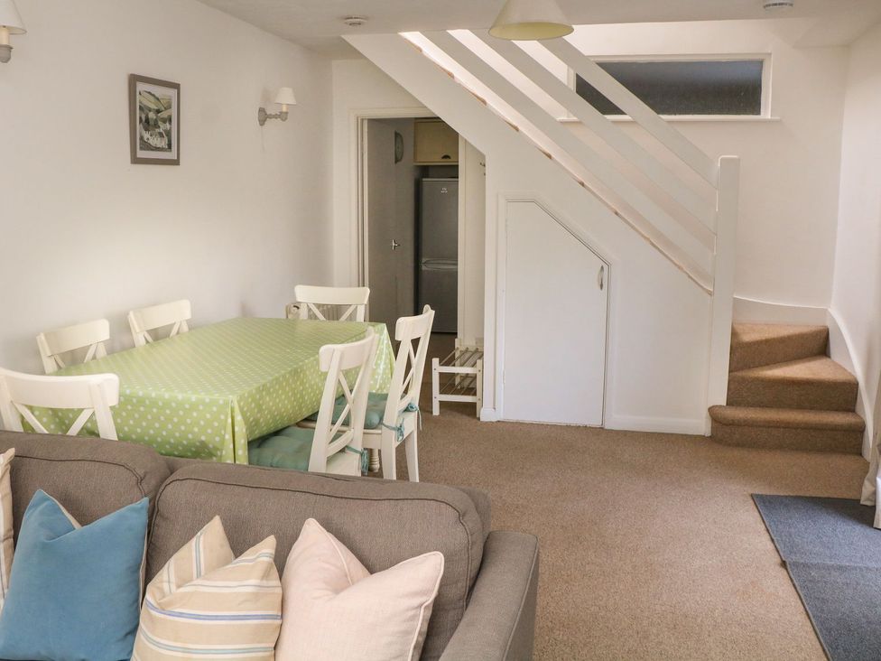 A living room with a dining table and chairs at 3 Moult Farm Cottages in Salcombe