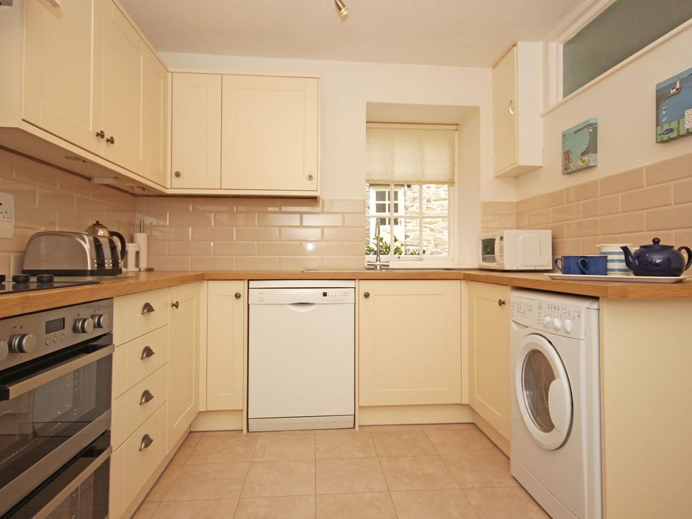 A kitchen with appliances and cabinets at 3 Moult Farm Cottages in Salcombe