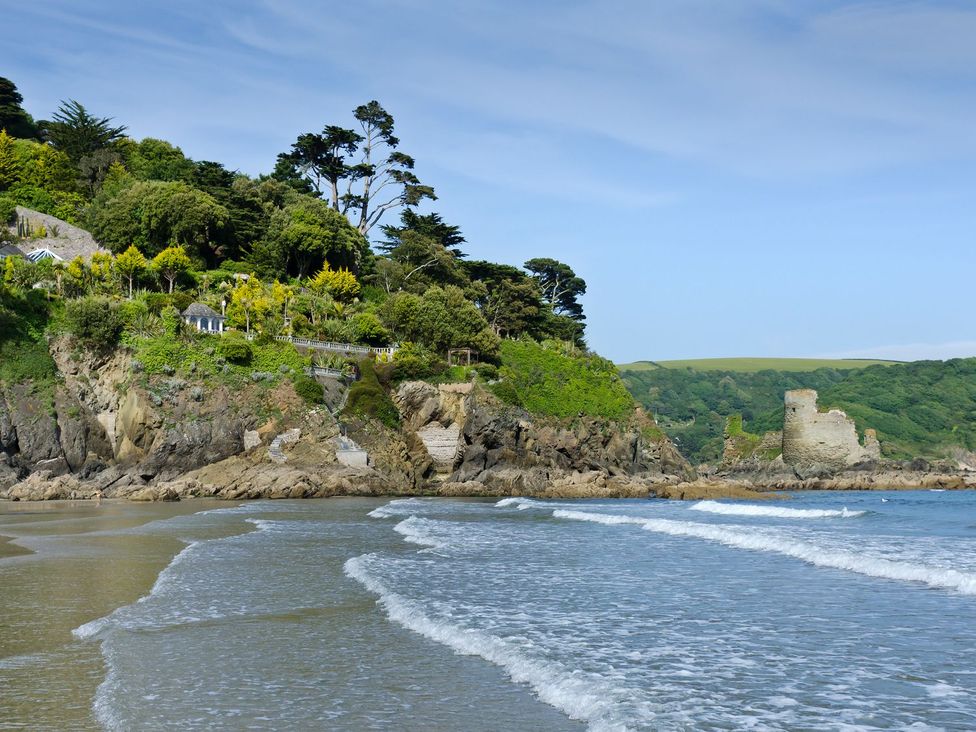 A beach scene with water and cliffs at 3 Moult Farm Cottages, Salcombe