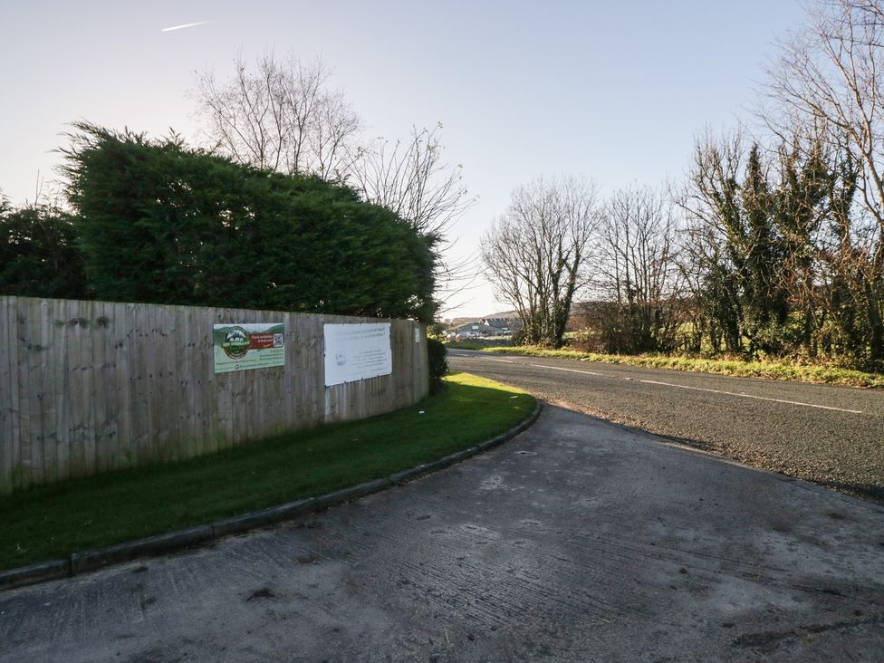 A road with trees and a fence at Pod 7 (Pet Friendly) in Tewitfield