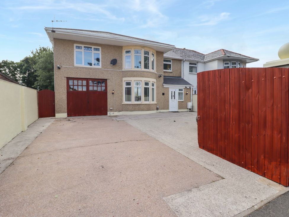 A house with a garage and driveway at William's Place in Barry