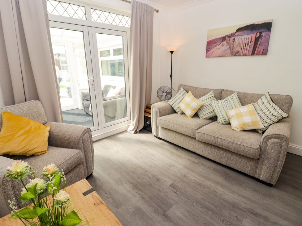 A living room with a sofa and armchair at William's Place in Barry