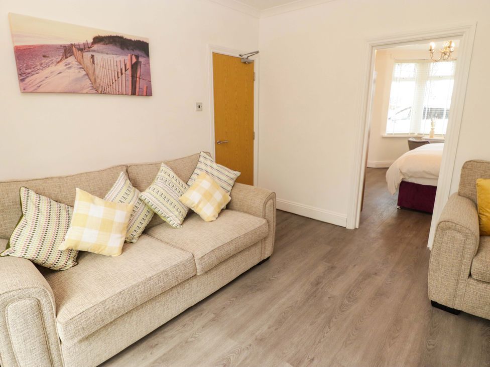 A living room with a sofa and a picture at William's Place in Barry
