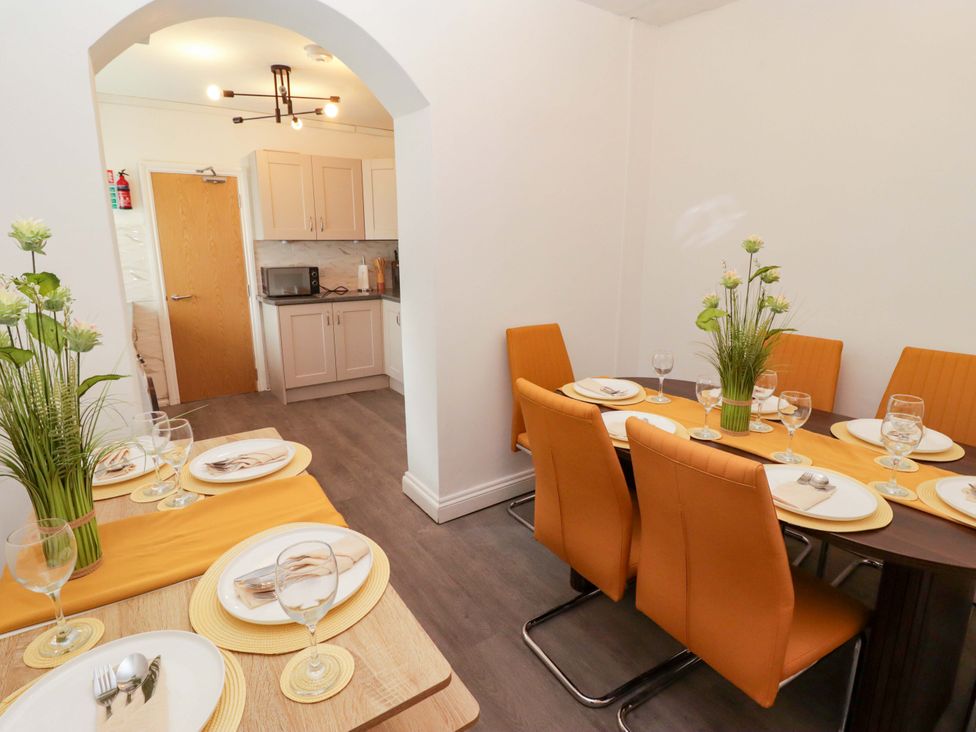 A dining room with a table set for dinner at William's Place in Barry
