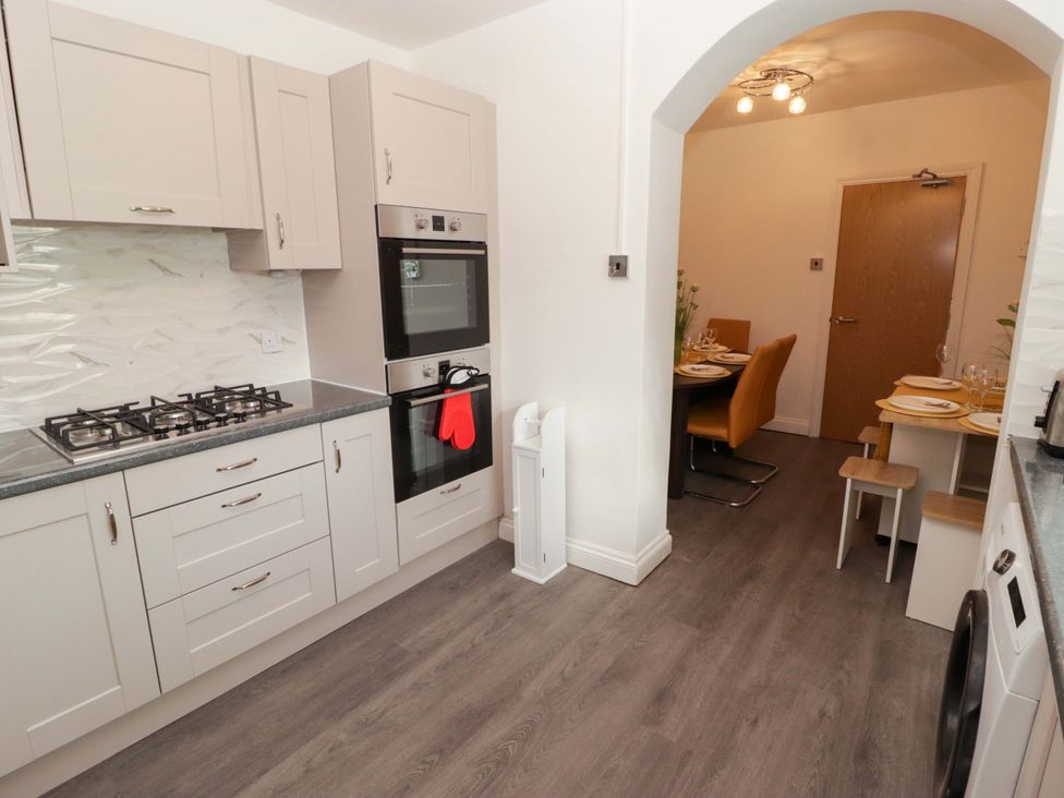 A kitchen with cabinets and appliances at William's Place in Barry