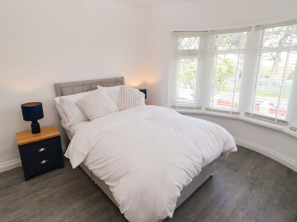 A bedroom with a bed and side table at William's Place in Barry