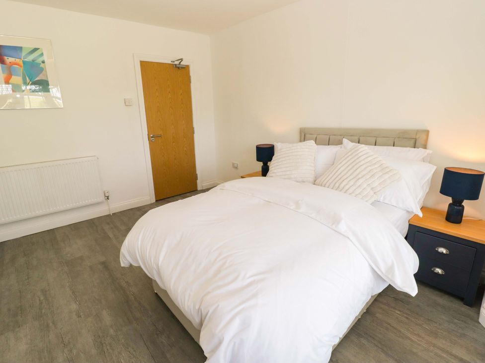 A bedroom with a double bed and bedside tables at William's Place in Barry