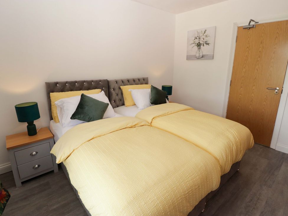 A bedroom with a double bed and nightstand at William's Place in Barry