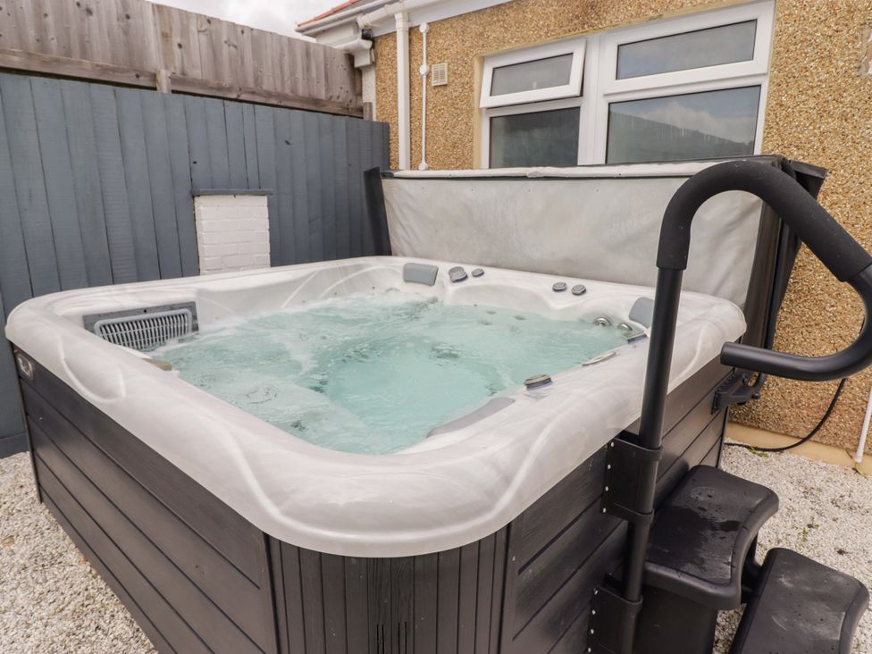 A hot tub with water and steps at William's Place in Barry