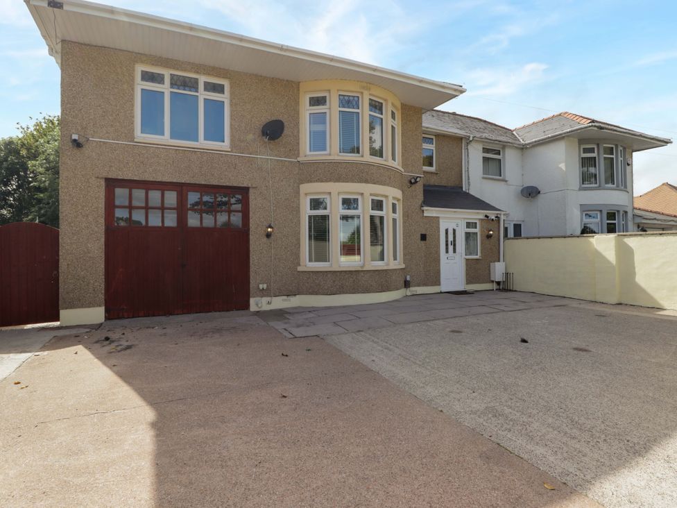 An exterior view of a house with a driveway and garage at William's Place in Barry