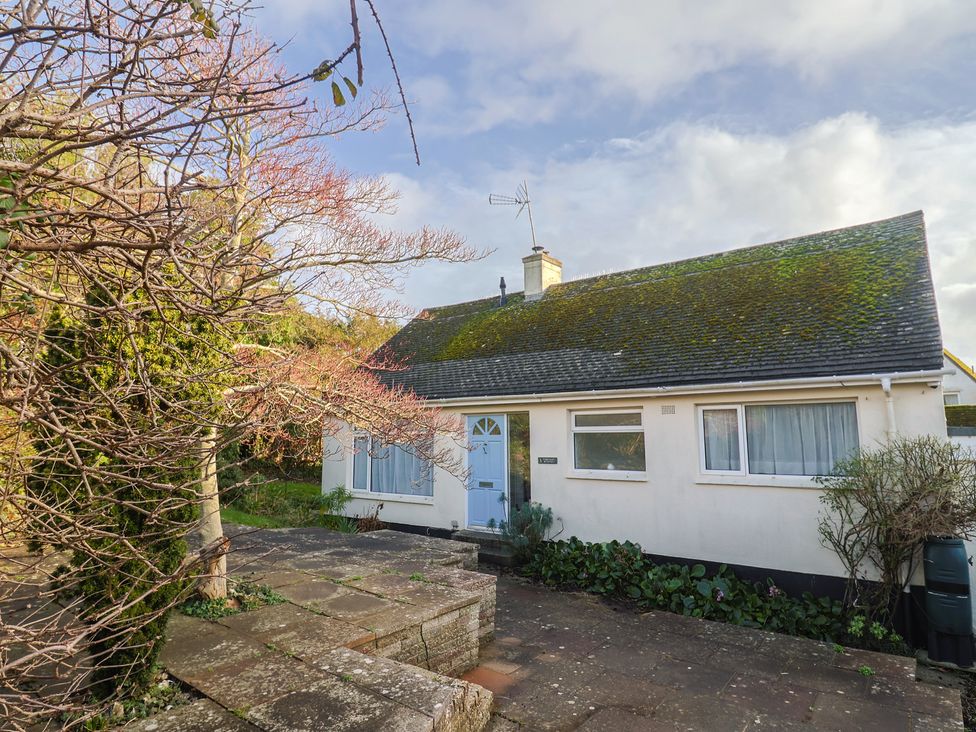 A house with a blue door and garden at Fluta in Seaton