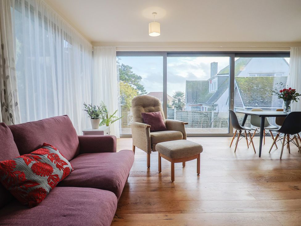 A living room with a sofa and dining table at Fluta in Seaton