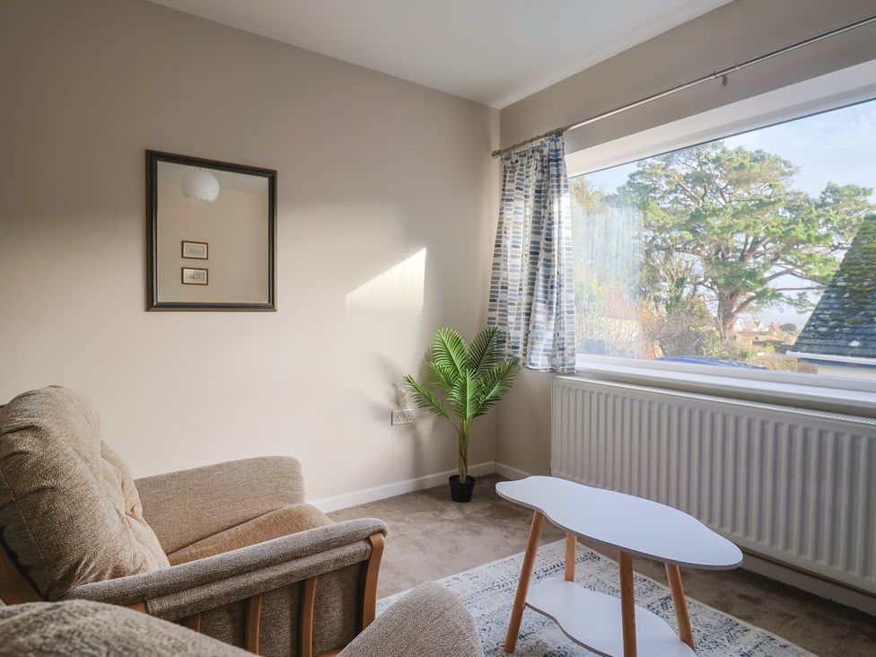 A living room with a sofa and coffee table at Fluta in Seaton