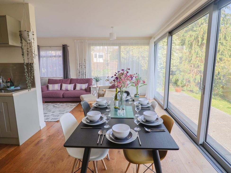 A dining area with a table set for meals at Fluta in Seaton
