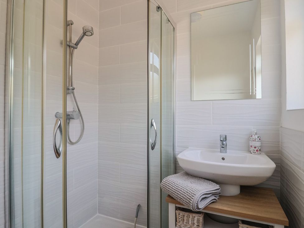 A bathroom with a shower and sink at Fluta in Seaton