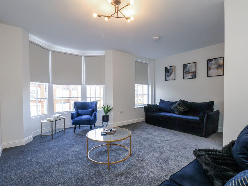 A living room with a sofa and armchair at 2 bed in Scarborough