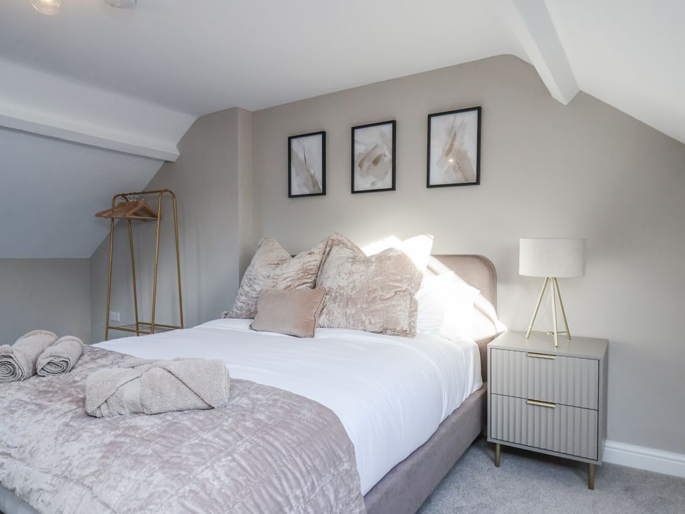 A bedroom with a bed and nightstand at 2 bed Scarborough