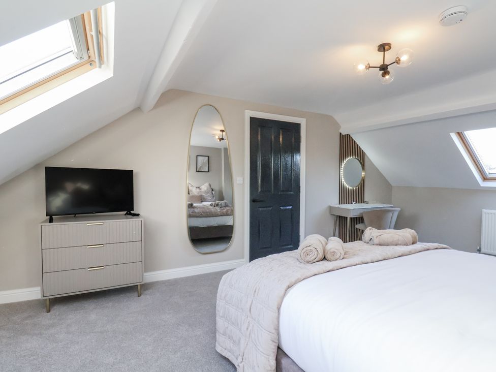 A bedroom with a bed and television at 2 bed in Scarborough