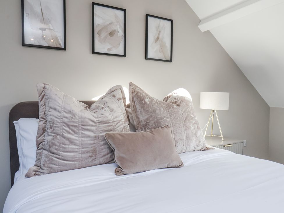 A bedroom with pillows and a lamp at 2 bed in Scarborough