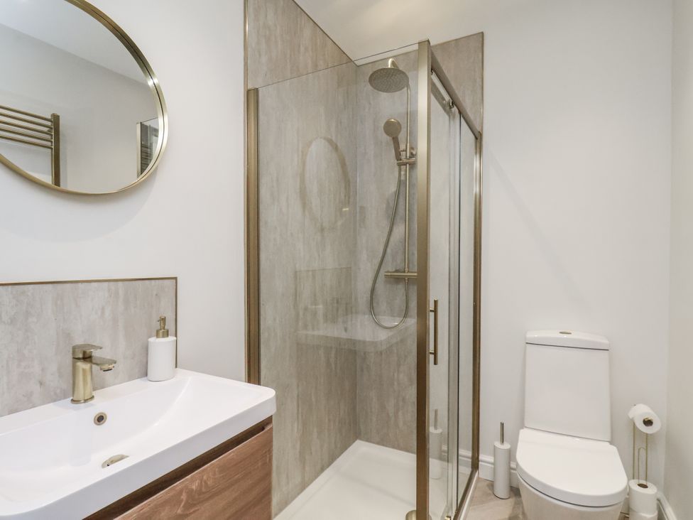 A bathroom with a shower and sink at 2 bed in Scarborough