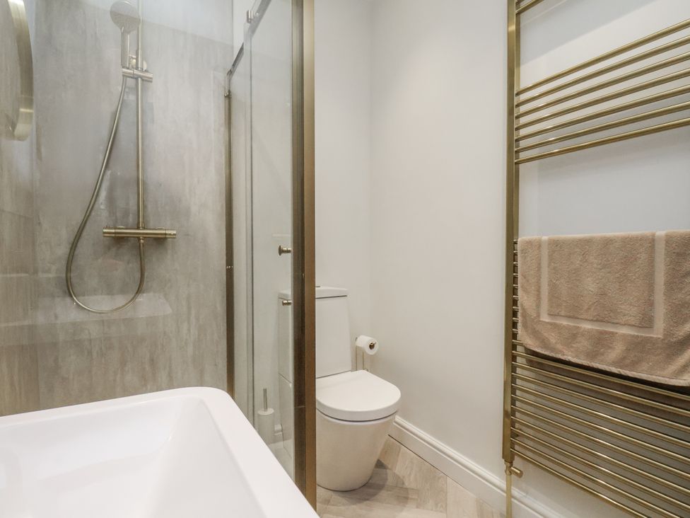 A bathroom with a shower and bathtub at 2 bed in Scarborough