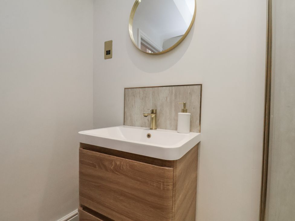 A bathroom with a sink and mirror at 2 bed Scarborough