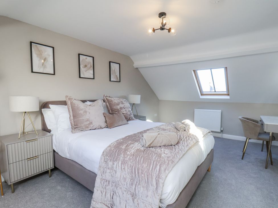 A bedroom with a bed and desk at 2 bed Scarborough