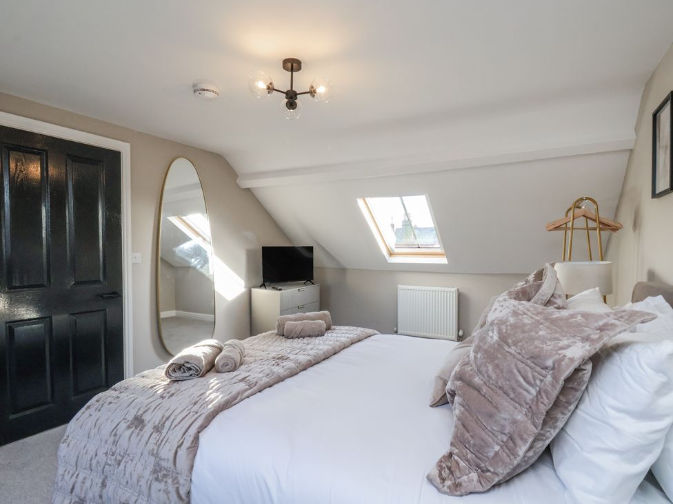 A bedroom with a bed and television at 2 bed in Scarborough