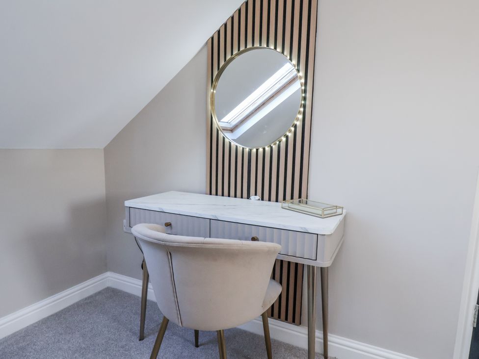 A vanity desk with a chair and a mirror at 2 bed in Scarborough