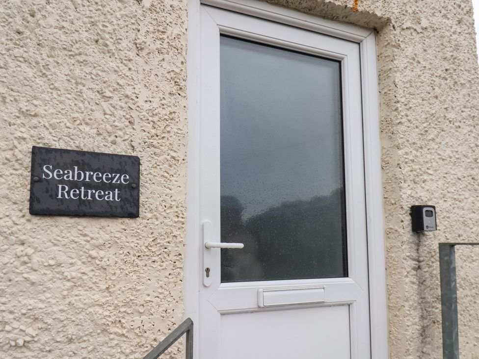 A door with a sign at Seabreeze Retreat in Scarborough