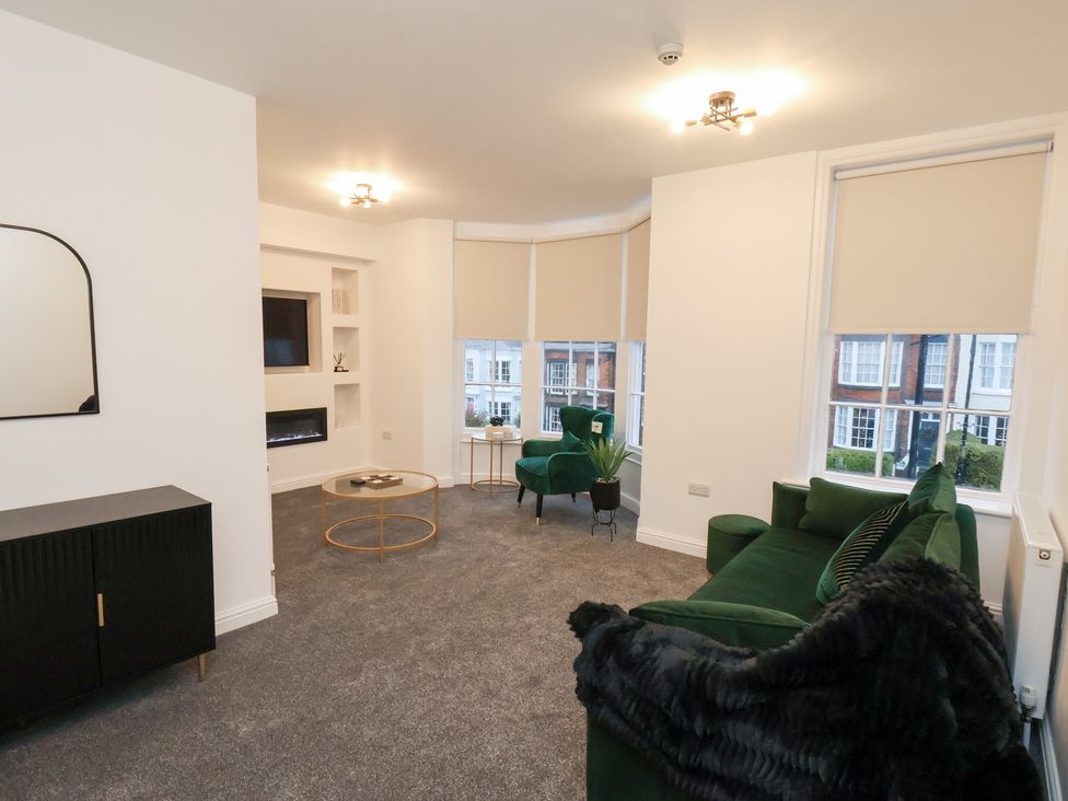 A living room with a sofa and coffee table at Maxwell View in Scarborough