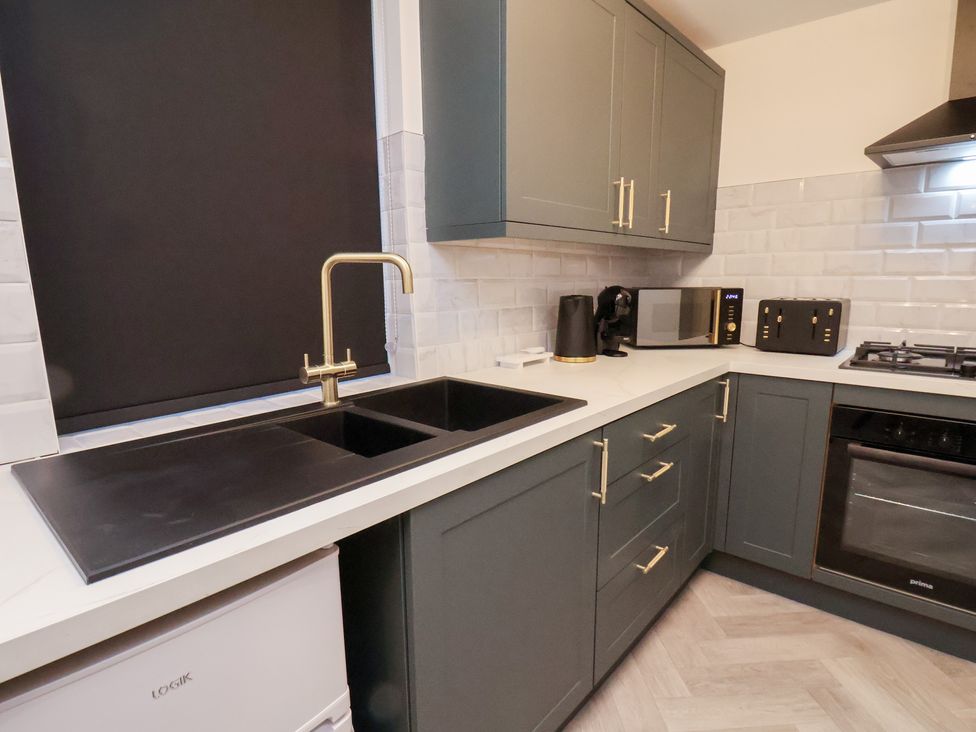 A kitchen with a sink and appliances at Maxwell View in Scarborough