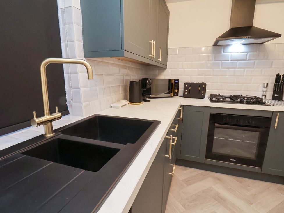 A kitchen with a sink and appliances at Maxwell View in Scarborough