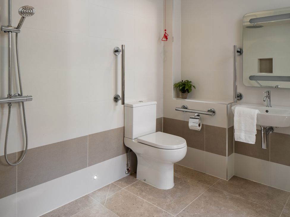 A bathroom with a shower, toilet, sink, and bathtub at The School House in Newton Abbot