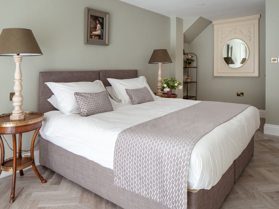 A bedroom with a bed and bedside table at The School House in Newton Abbot