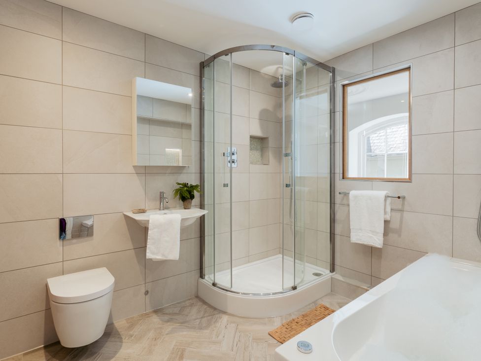 A bathroom with a shower, toilet, sink and bathtub at The School House in Newton Abbot