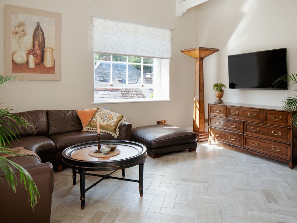 A living room with a coffee table and sofa at Upper School House in Newton Abbot