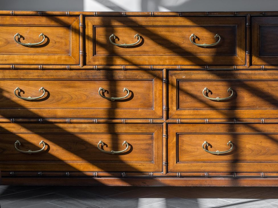 A wooden dresser with several drawers at Upper School House in Newton Abbot