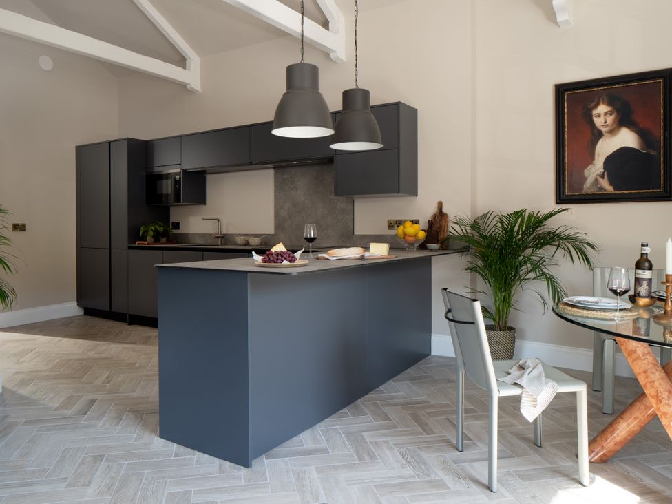 A kitchen with an island and dining area at Upper School House in Newton Abbot